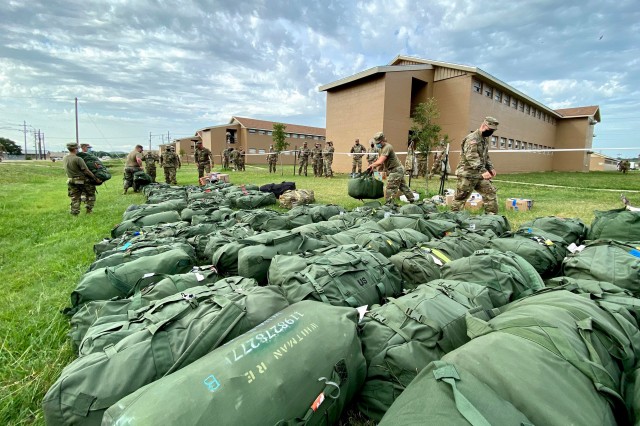 Image: U.S. Soldiers with the 28th Expeditionary Combat Aviation Brigade unload bags from a truck at their mobilization station at Fort Hood, Texas. They are at their mobilization to train, after which the 28th ECAB will deploy to the Middle East where they will assist U.S. Central Command’s mission of increasing regional security and stability in support of U.S. interests. (Photo Credit: Capt. Travis Mueller)