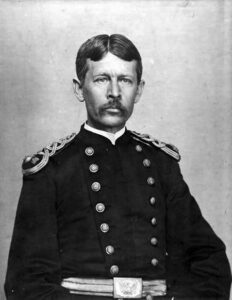 Soldier in dress uniform seated facing the camera. 